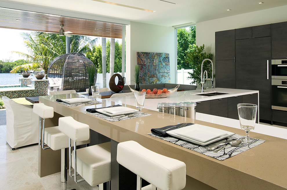 Inspiration for a contemporary open plan kitchen in Miami with flat-panel cabinets, dark wood cabinets and panelled appliances.