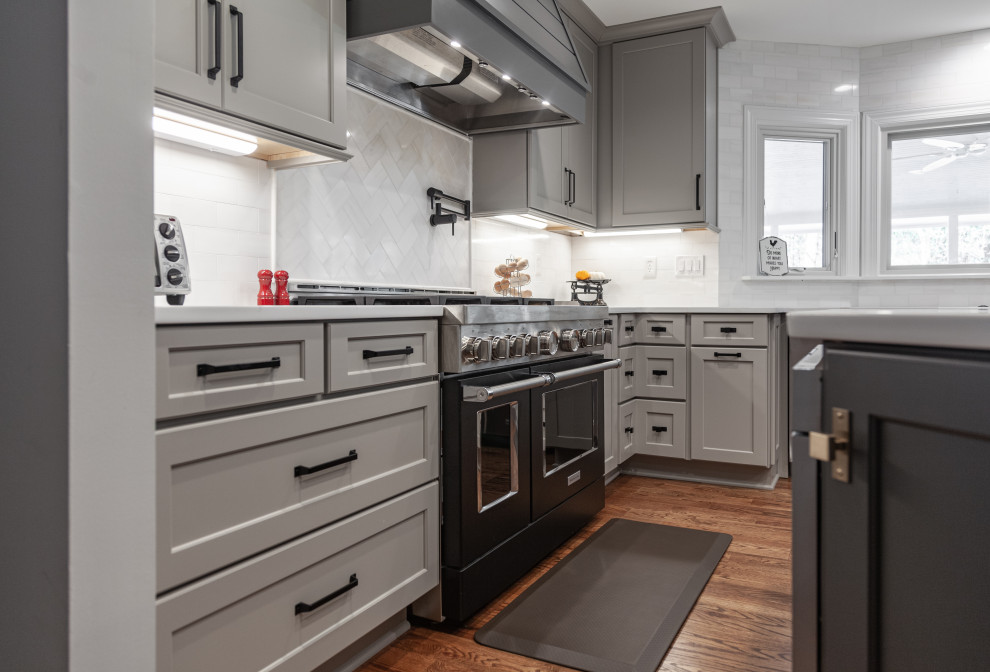 Inspiration for a huge contemporary medium tone wood floor eat-in kitchen remodel in Atlanta with a farmhouse sink, shaker cabinets, quartz countertops, white backsplash, marble backsplash, stainless steel appliances, an island and white countertops