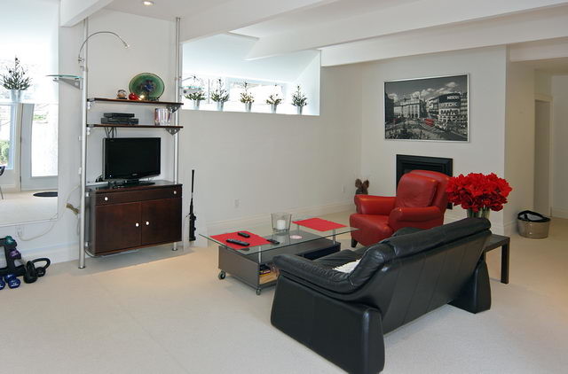 Inspiration for a large transitional walk-out basement remodel in Toronto with white walls