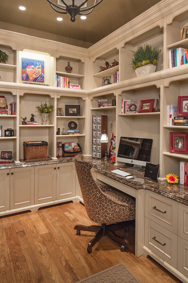 Photo of a mid-sized traditional study room in Omaha with medium hardwood floors and a built-in desk.