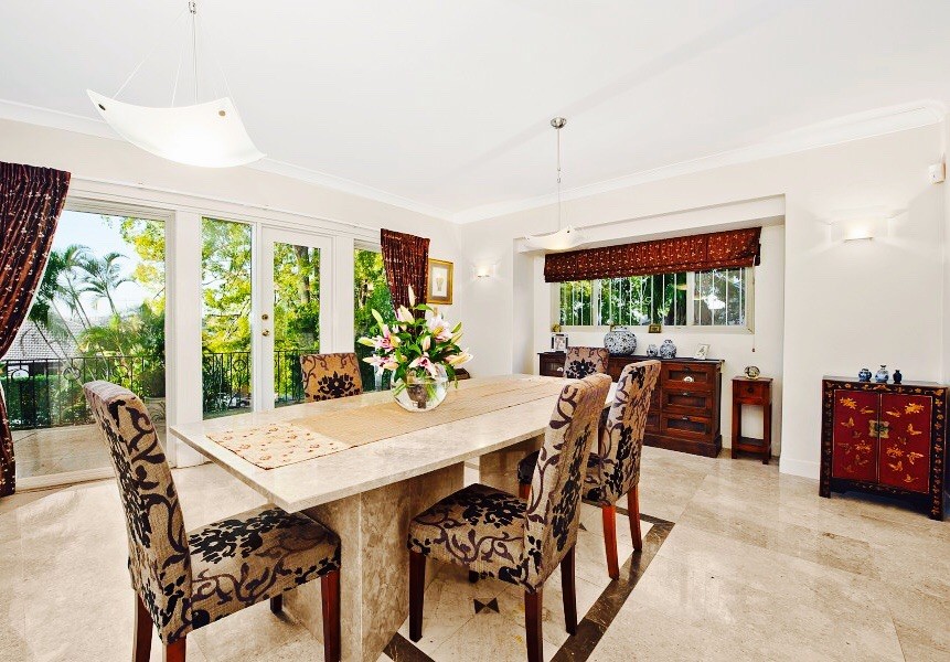 Photo of a mid-sized asian separate dining room in Brisbane with white walls, limestone floors and beige floor.