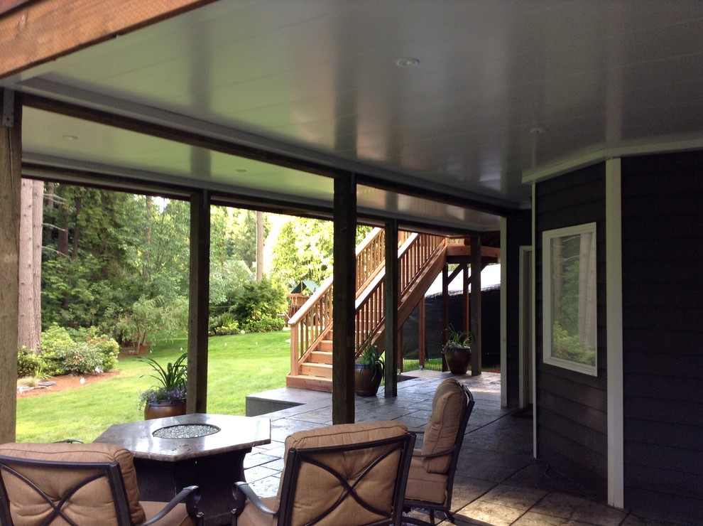 Patio - mid-sized transitional backyard stamped concrete patio idea in Seattle with a fire pit