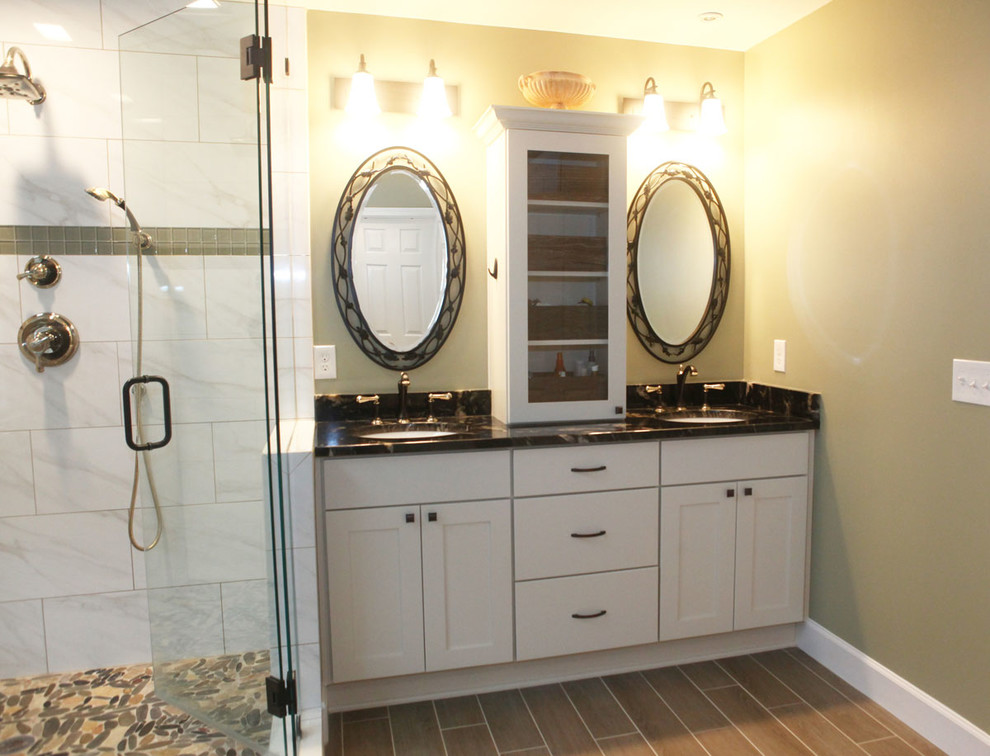 This is an example of a large modern master bathroom in Atlanta with an undermount sink, shaker cabinets, white cabinets, marble benchtops, a freestanding tub, a corner shower, white tile, ceramic tile, beige walls and porcelain floors.