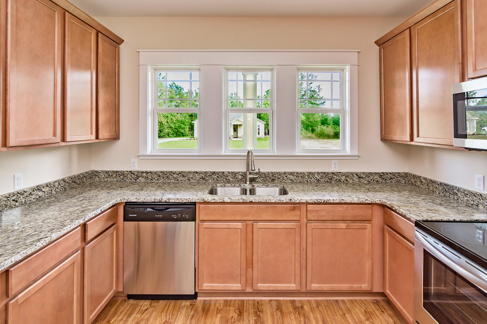 Eat-in kitchen - mid-sized craftsman u-shaped laminate floor eat-in kitchen idea with a double-bowl sink, recessed-panel cabinets, light wood cabinets, granite countertops, stainless steel appliances and no island