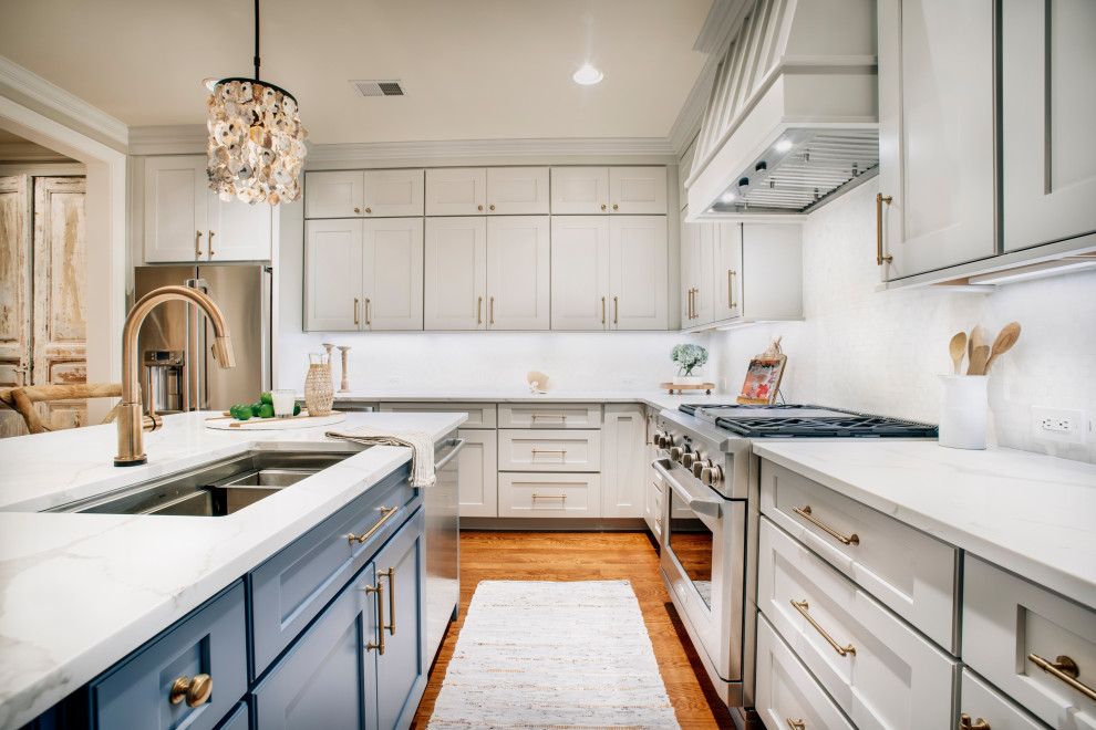 Design ideas for a transitional kitchen in Nashville with an undermount sink, grey cabinets, stainless steel appliances, dark hardwood floors, with island, brown floor and white benchtop.