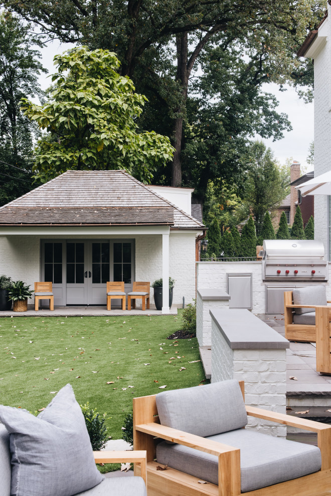 ASC Margaritaville - Example of a large transitional backyard brick patio kitchen design in Chicago with no cover