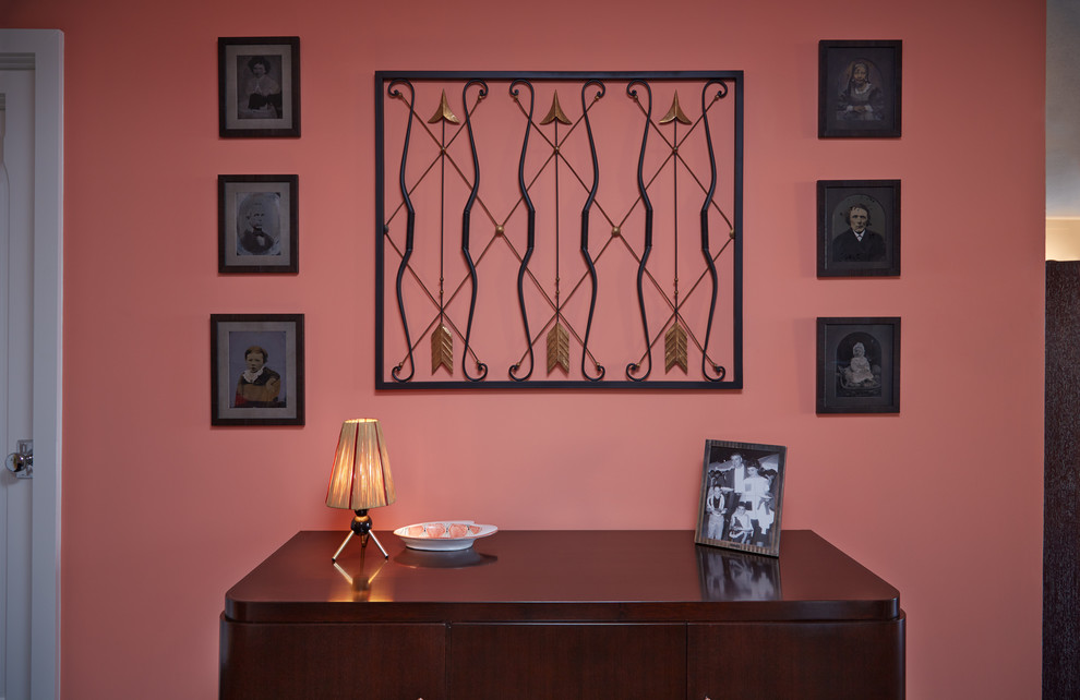 Inspiration for a small midcentury foyer in New York with pink walls and dark hardwood floors.