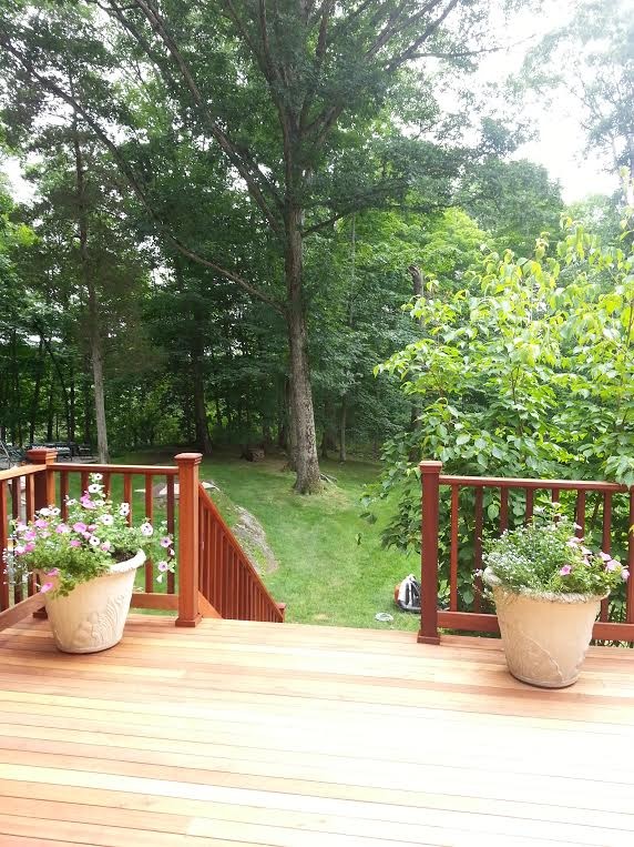 This is an example of a large traditional backyard deck in New York with no cover.
