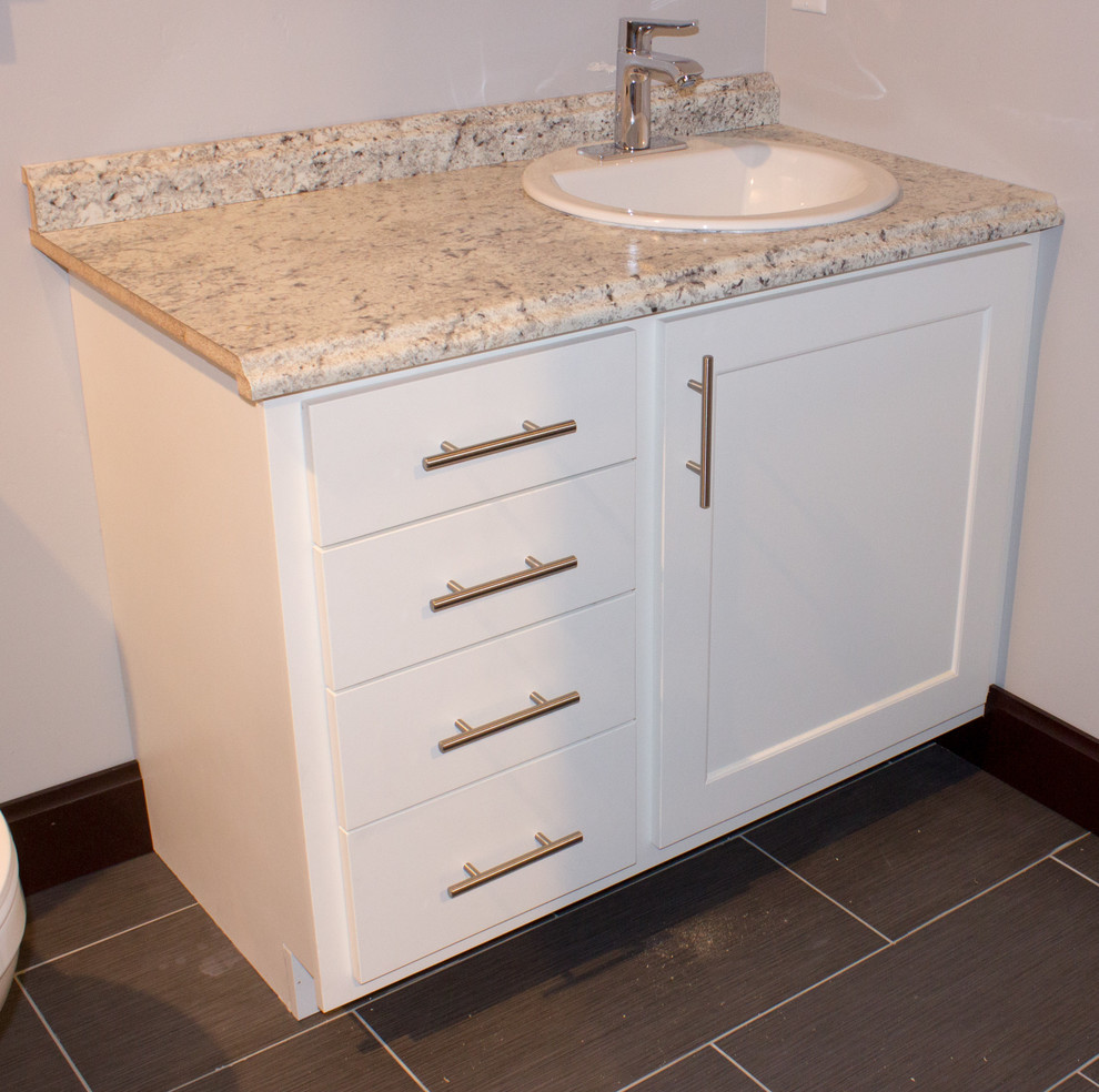 Example of a mid-sized transitional single-wall medium tone wood floor and brown floor eat-in kitchen design with an undermount sink, shaker cabinets, white cabinets, granite countertops, stainless steel appliances and an island