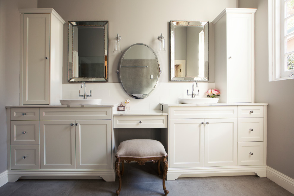 Inspiration for a mid-sized traditional 3/4 bathroom in Perth with white cabinets, a two-piece toilet, white tile, ceramic tile, grey walls, ceramic floors, a vessel sink, grey floor, white benchtops and recessed-panel cabinets.