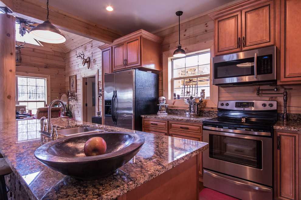 Example of a mid-sized mountain style galley eat-in kitchen design with an undermount sink, raised-panel cabinets, medium tone wood cabinets, granite countertops, wood backsplash, stainless steel appliances and an island