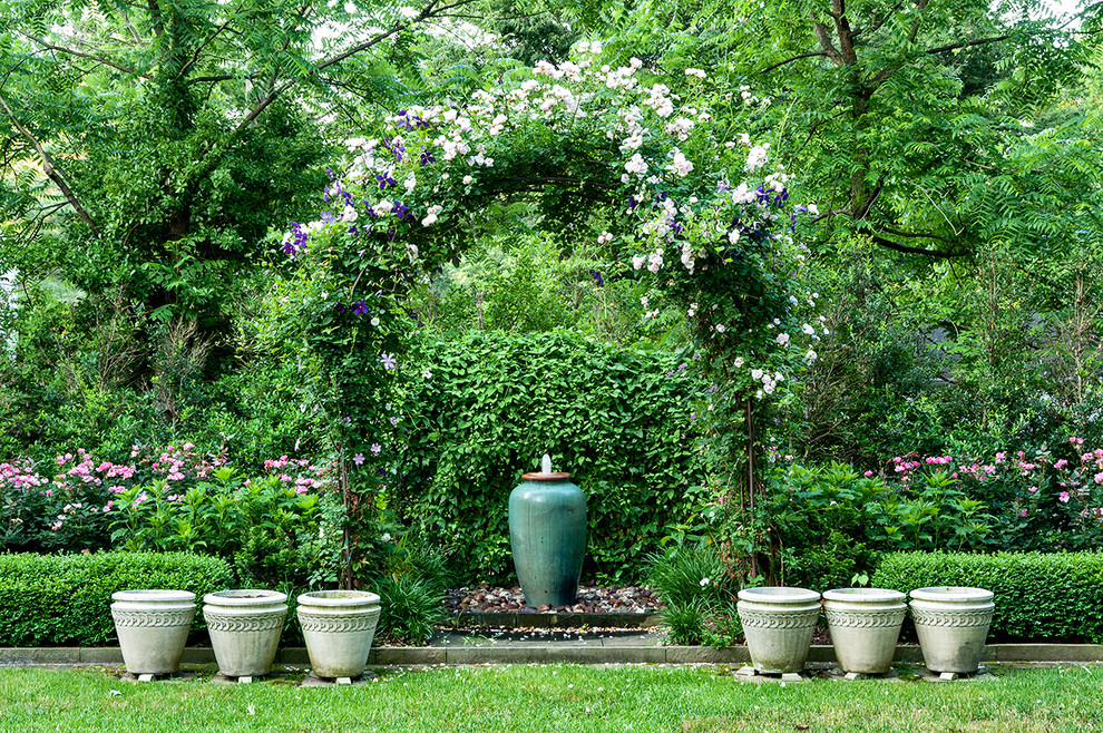 Design ideas for a mid-sized traditional backyard partial sun garden for spring in DC Metro with a water feature and natural stone pavers.