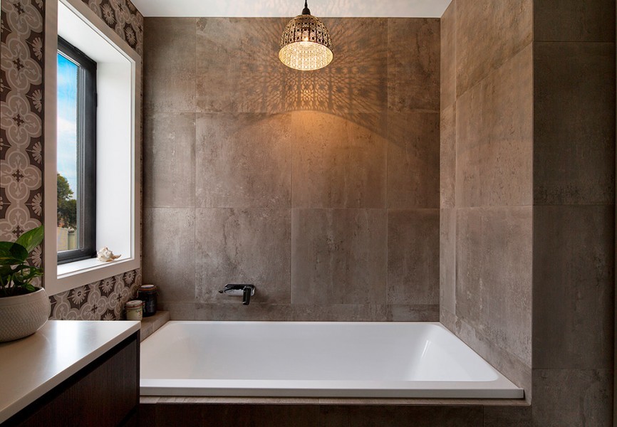 Inspiration for an eclectic bathroom in Melbourne with dark wood cabinets, a drop-in tub, brown tile, porcelain tile, flat-panel cabinets, brown walls, porcelain floors, engineered quartz benchtops, brown floor and brown benchtops.