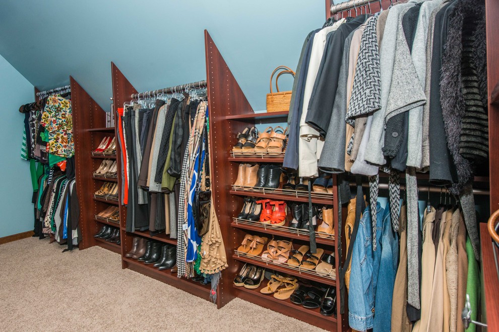 Large traditional gender-neutral walk-in wardrobe in Philadelphia with open cabinets, brown cabinets, carpet and beige floor.