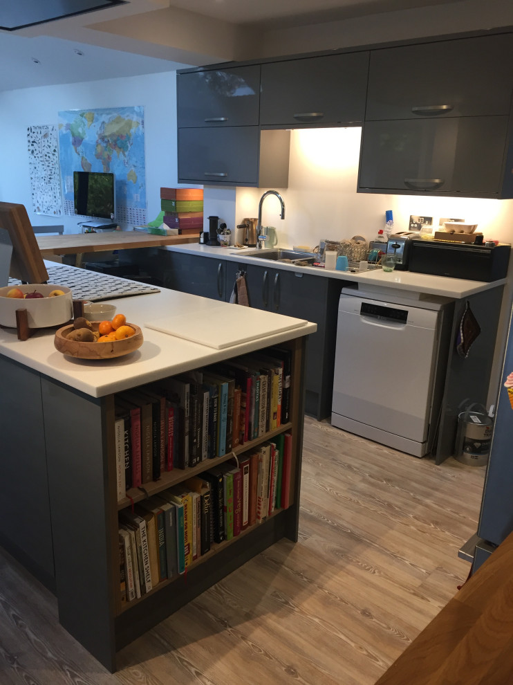 Photo of a medium sized traditional u-shaped kitchen/diner in Other with flat-panel cabinets, grey cabinets, soapstone worktops, porcelain flooring and a breakfast bar.