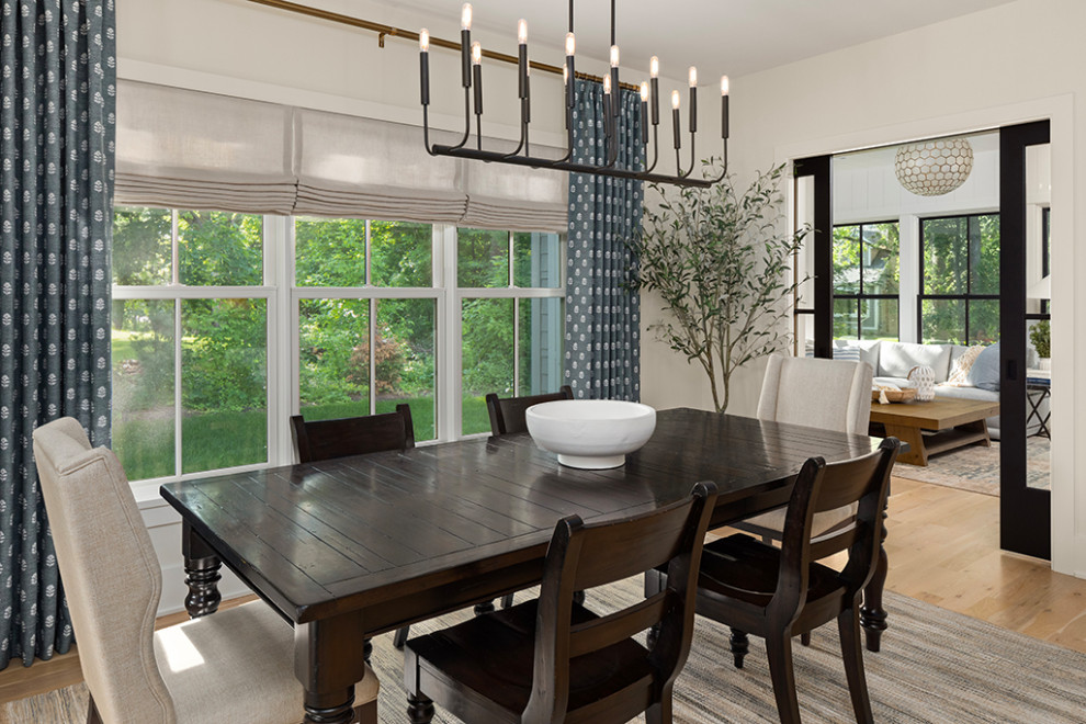 Photo of a transitional open plan dining in Minneapolis with white walls, medium hardwood floors and brown floor.