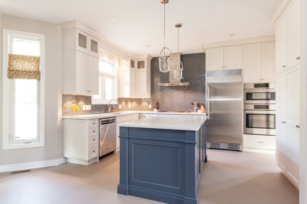 Inspiration for a large transitional u-shaped porcelain tile and gray floor eat-in kitchen remodel in Toronto with an undermount sink, recessed-panel cabinets, white cabinets, quartz countertops, gray backsplash, subway tile backsplash, stainless steel appliances, an island and white countertops