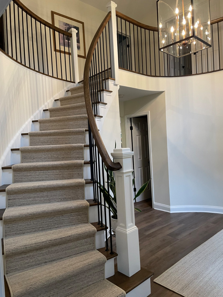 Country wood staircase in New York with painted wood risers and wood railing.