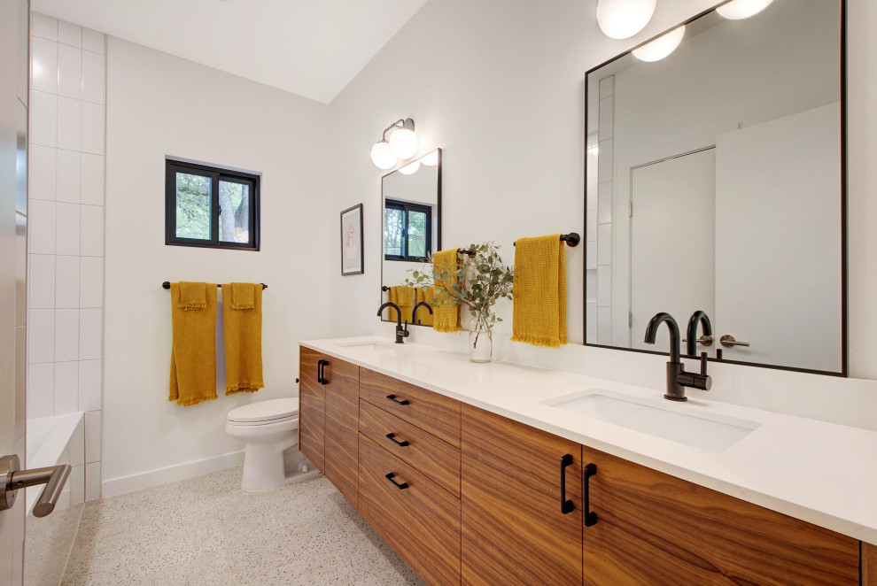 Example of a mid-sized danish kids' white tile and porcelain tile porcelain tile, white floor and double-sink bathroom design in Austin with flat-panel cabinets, brown cabinets, a one-piece toilet, white walls, an undermount sink, quartz countertops, white countertops, a niche and a floating vanity