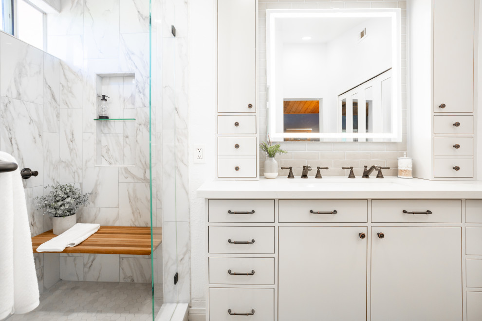 Photo of a medium sized traditional ensuite bathroom in Santa Barbara with flat-panel cabinets, grey cabinets, an alcove shower, a one-piece toilet, ceramic tiles, white walls, vinyl flooring, a trough sink, engineered stone worktops, brown floors, a hinged door, white worktops, a shower bench, a single sink, a built in vanity unit and a vaulted ceiling.