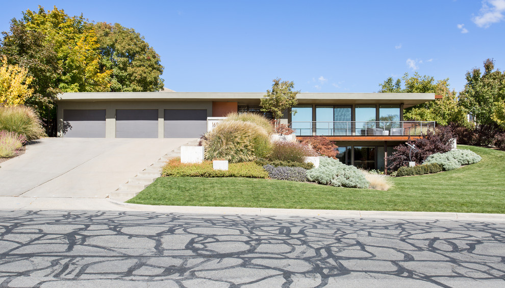 Inspiration for a large midcentury two-storey stucco multi-coloured house exterior in Salt Lake City with a flat roof.