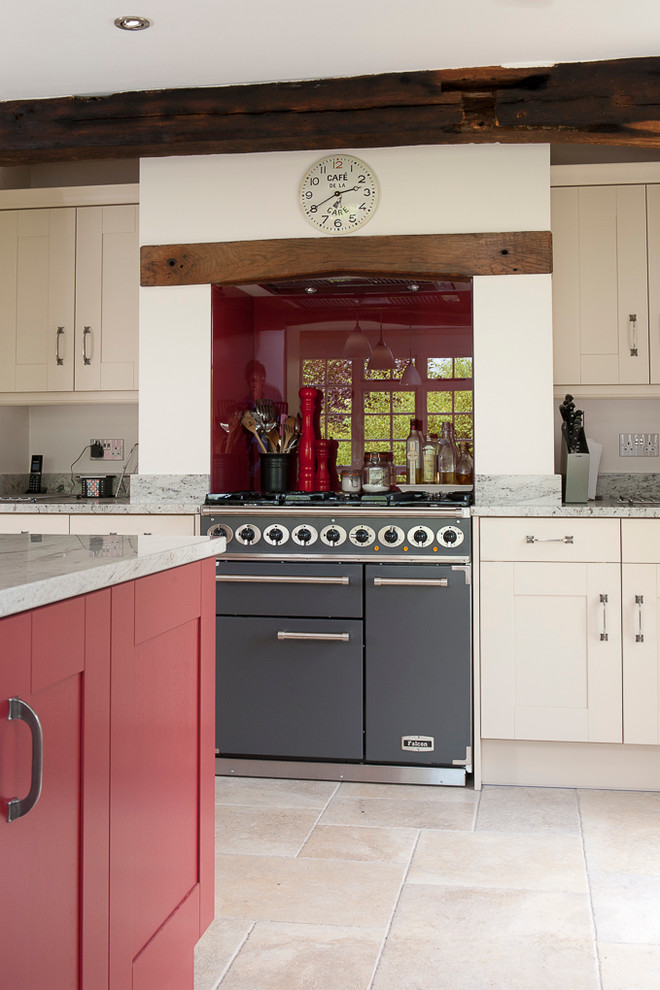 This is an example of a large traditional eat-in kitchen in Kent with a double-bowl sink, red cabinets, granite benchtops, red splashback, panelled appliances, porcelain floors and with island.