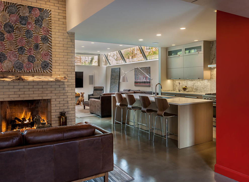 This is an example of a mid-sized contemporary formal open concept living room in Chicago with concrete floors, multi-coloured walls, a standard fireplace, a brick fireplace surround and no tv.