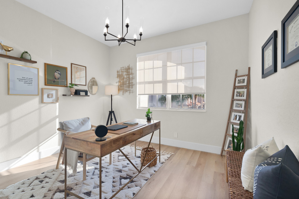 Design ideas for a mid-sized scandinavian study room in Miami with white walls, vinyl floors, a freestanding desk, beige floor and vaulted.