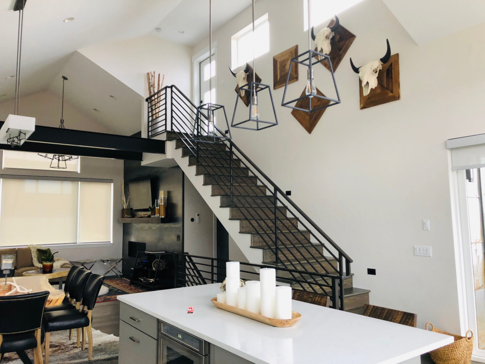 Transitional medium tone wood floor and gray floor kitchen photo in Denver with gray cabinets, stainless steel appliances, an island and white countertops