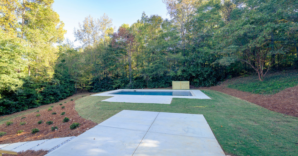 Inspiration for a large transitional backyard stone and rectangular pool remodel in Atlanta