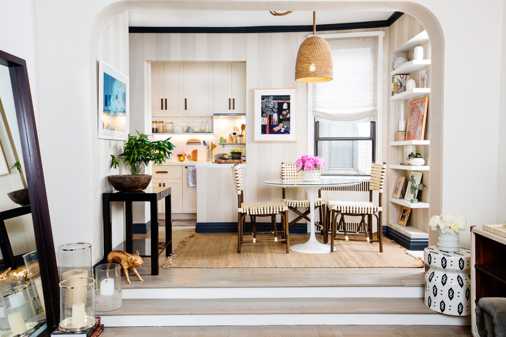 Small transitional kitchen/dining combo in New York with multi-coloured walls, light hardwood floors, no fireplace and beige floor.