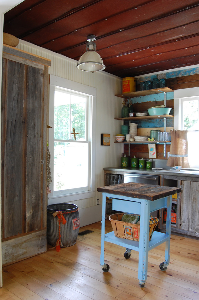 This is an example of a country kitchen in New York with open cabinets and distressed cabinets.