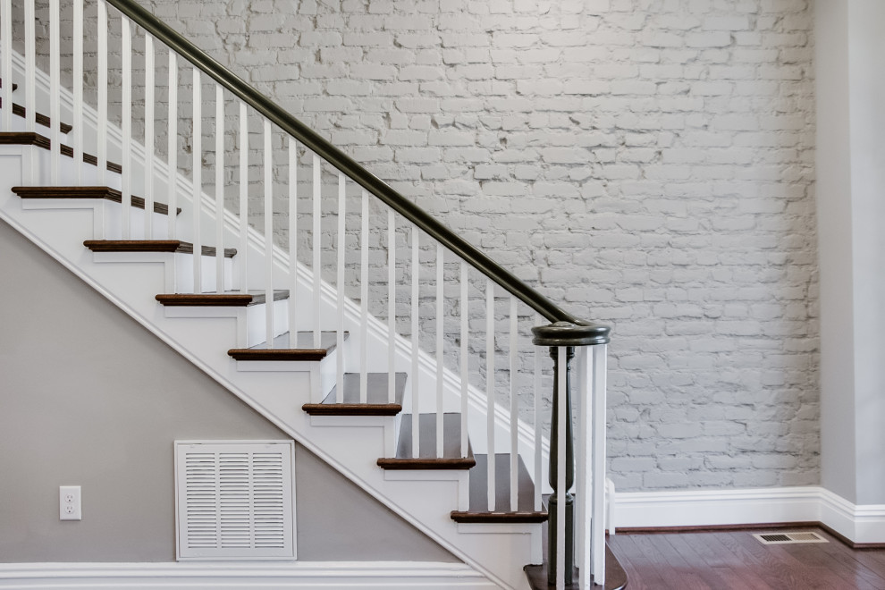 Mid-sized transitional wood straight staircase in Richmond with wood risers and wood railing.