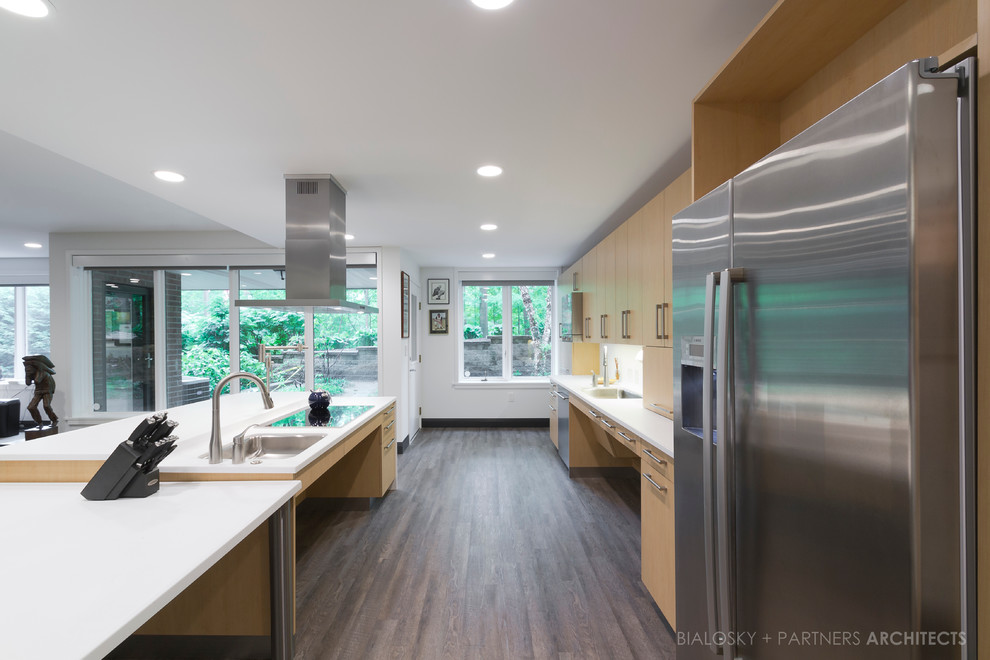 Mid-sized contemporary eat-in kitchen in Cleveland with light wood cabinets, an undermount sink, flat-panel cabinets, quartz benchtops, white splashback, porcelain splashback, stainless steel appliances, dark hardwood floors and with island.
