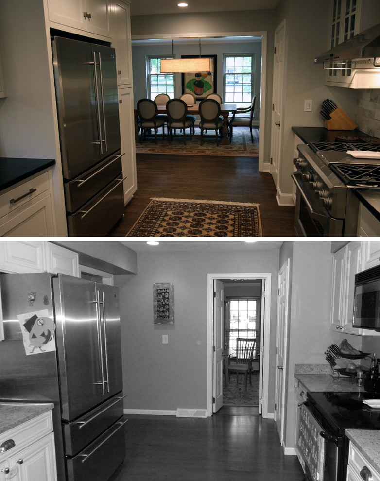 Example of a mid-sized l-shaped dark wood floor kitchen design with a farmhouse sink, flat-panel cabinets, white cabinets, soapstone countertops, stainless steel appliances and a peninsula