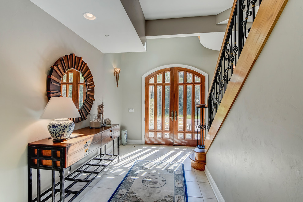 Mid-sized transitional porcelain tile foyer photo in Miami with blue walls and a medium wood front door