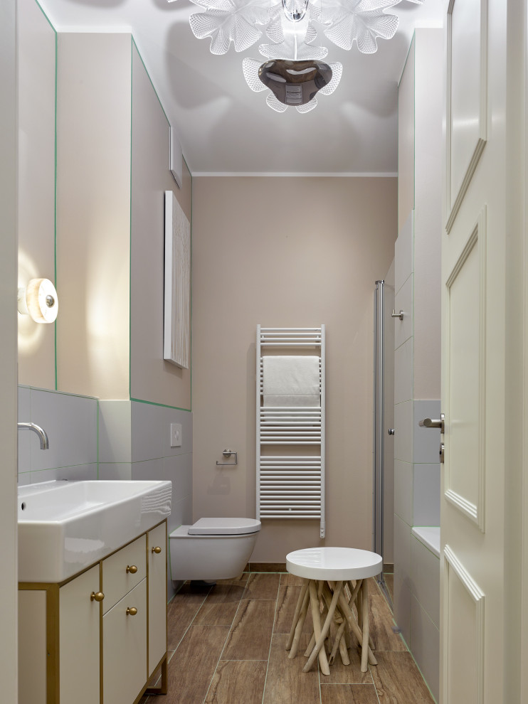 This is an example of an eclectic master bathroom in Other with an alcove tub, gray tile, beige walls, a freestanding vanity, flat-panel cabinets, white cabinets, an alcove shower, wood-look tile, a console sink, brown floor and a single vanity.