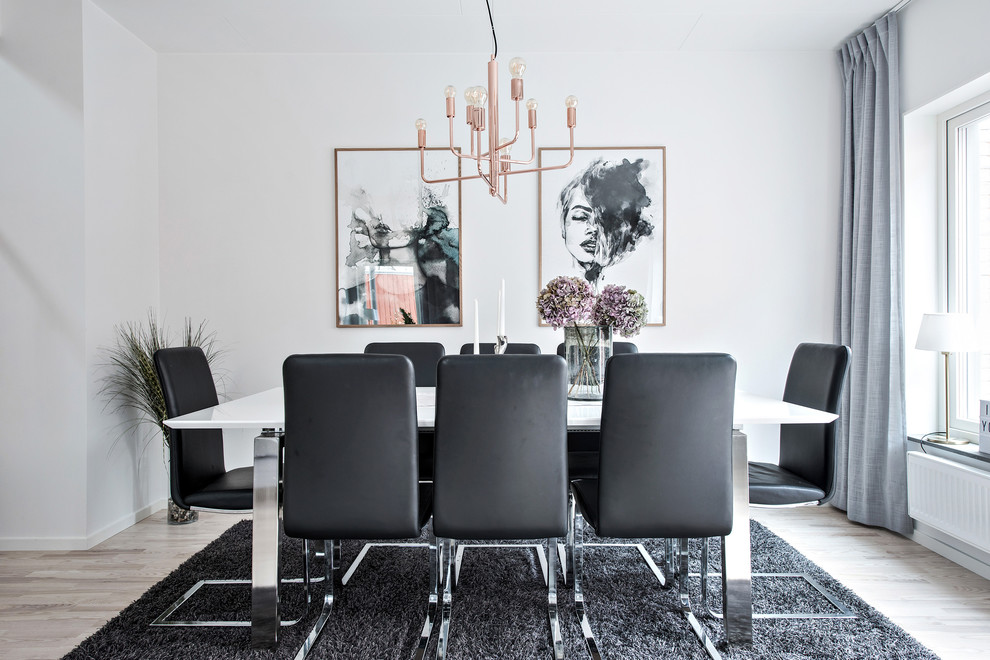 Photo of a mid-sized contemporary separate dining room in Gothenburg with white walls, light hardwood floors, no fireplace and beige floor.