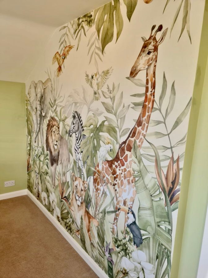 This is an example of a modern gender neutral kids' bedroom in Oxfordshire with green walls and wallpapered walls.