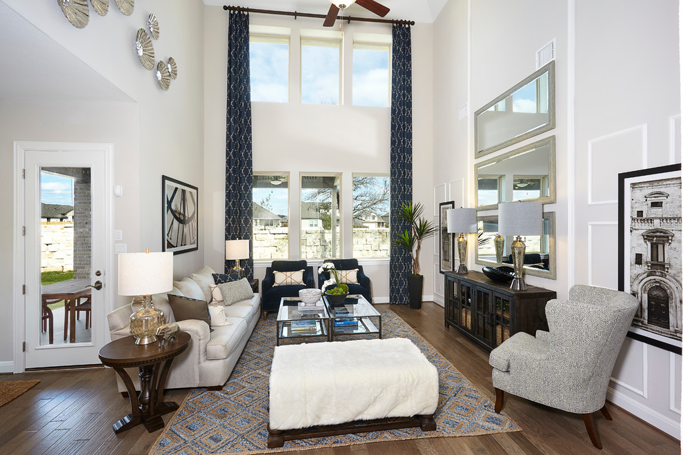 Large contemporary open concept living room in Austin with white walls and dark hardwood floors.