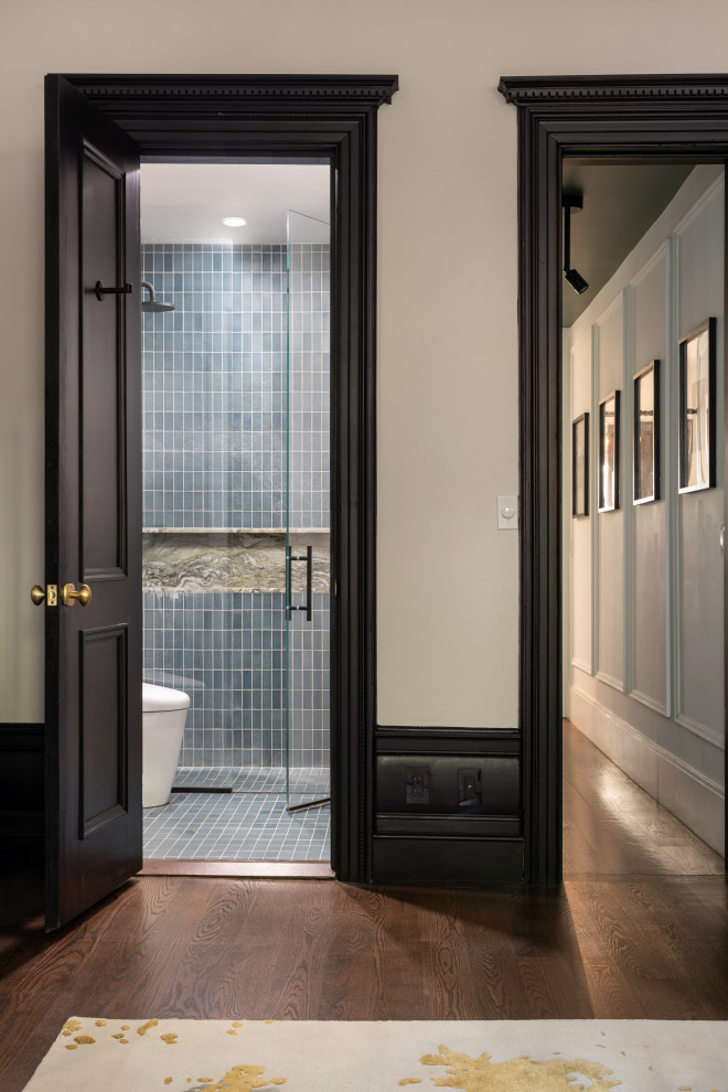 Small transitional master bathroom in New York with a curbless shower, a bidet, blue tile, ceramic tile, ceramic floors, a pedestal sink, tile benchtops, blue floor, a hinged shower door, a niche, a single vanity and brick walls.
