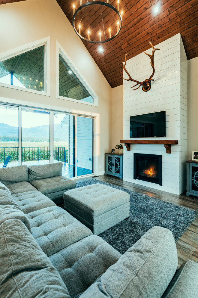 Inspiration for a large cottage open concept dark wood floor and wood ceiling living room remodel in Vancouver with a standard fireplace, a shiplap fireplace and a wall-mounted tv