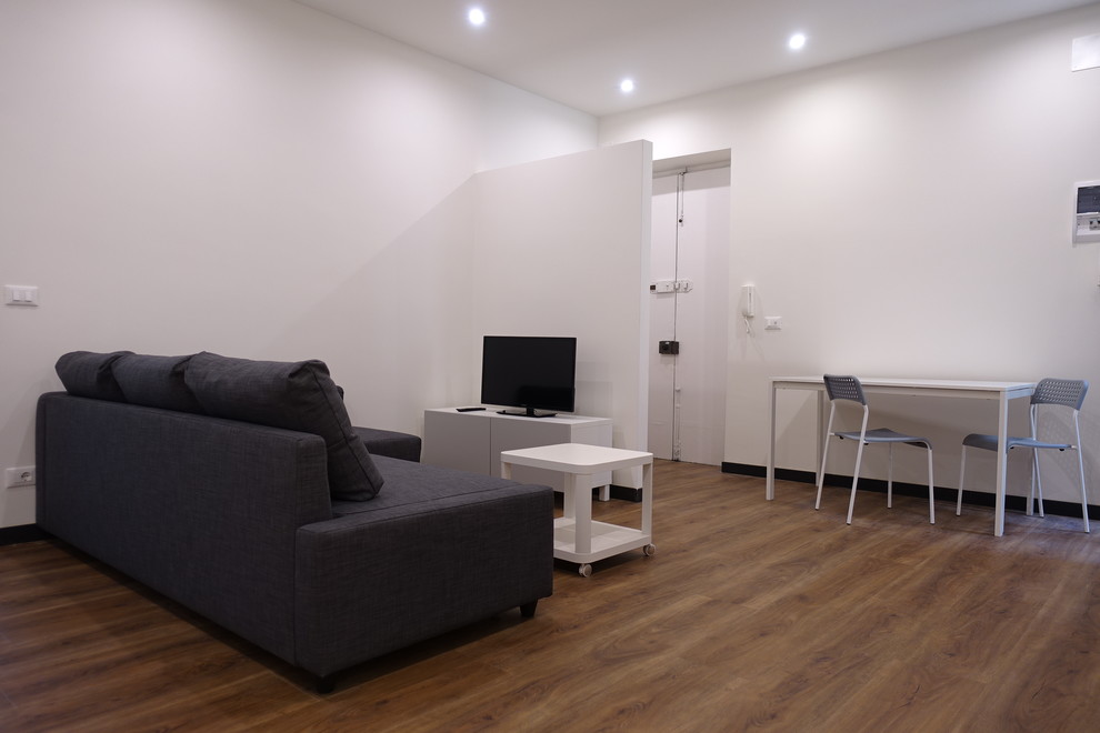 Foto di un soggiorno minimal di medie dimensioni e aperto con pareti bianche e pavimento in laminato