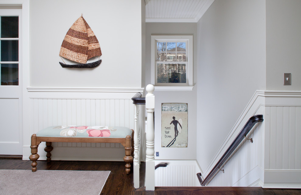 This is an example of a beach style hallway in New York with grey walls and dark hardwood floors.