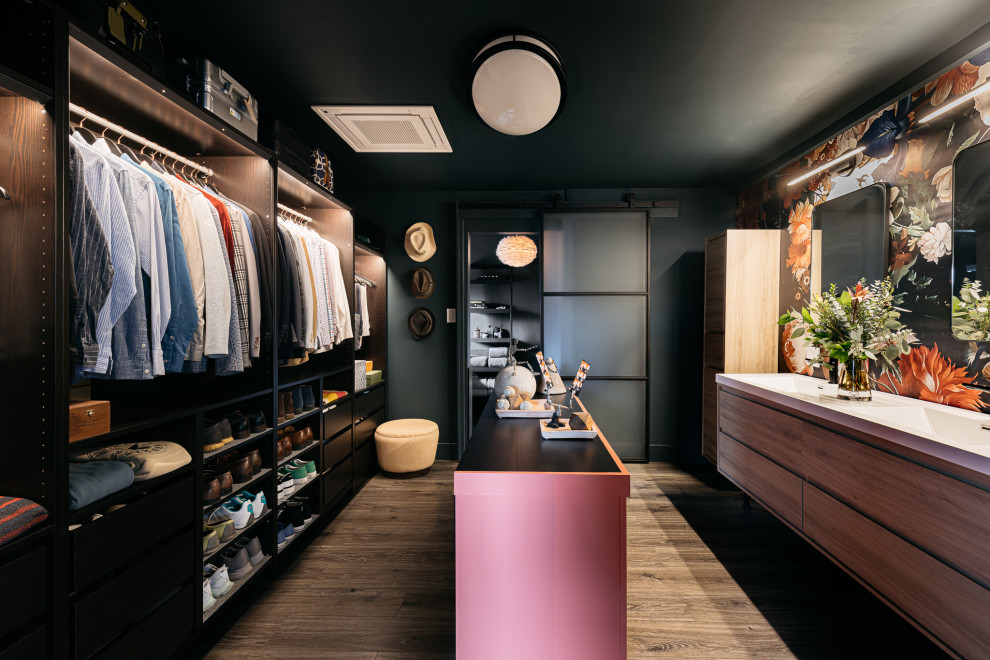 This is an example of a contemporary men's walk-in wardrobe in Los Angeles with open cabinets, black cabinets, dark hardwood floors, brown floor and wallpaper.