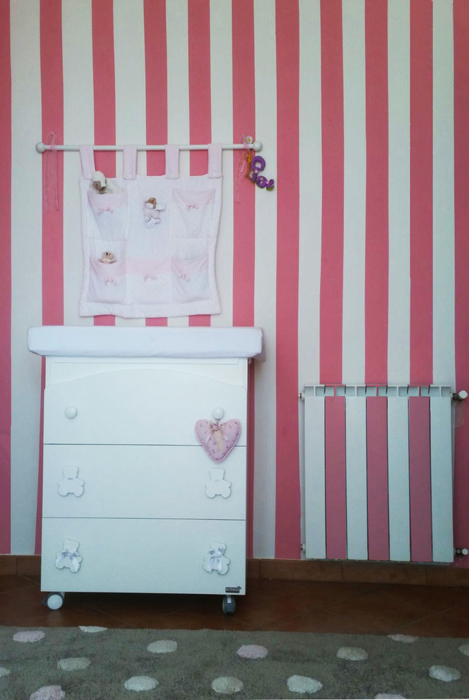 Design ideas for a mid-sized modern nursery for girls in Catania-Palermo with pink walls.