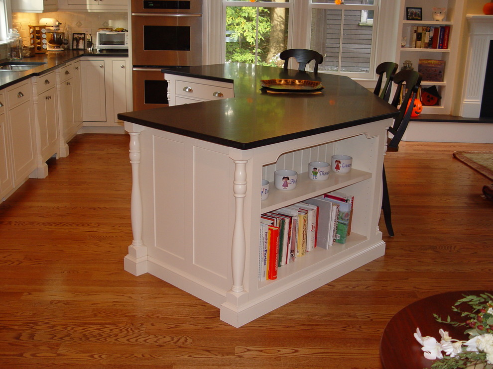 Inspiration for a transitional medium tone wood floor eat-in kitchen remodel in Boston with an undermount sink, beaded inset cabinets, white cabinets, granite countertops, white backsplash, subway tile backsplash, paneled appliances, yellow walls and an island