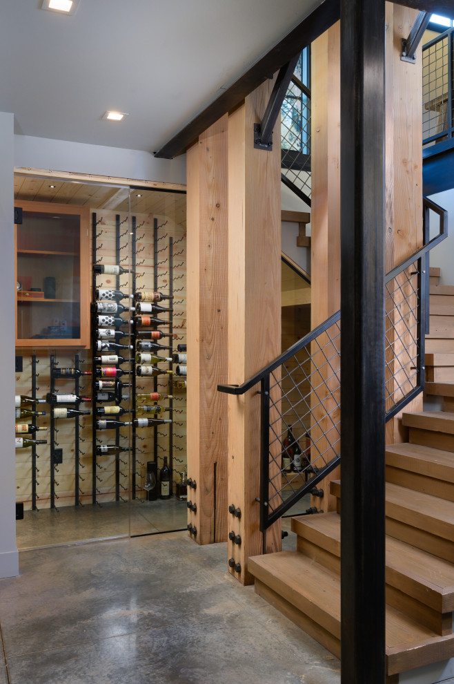 Design ideas for an industrial wine cellar in Other with display racks.