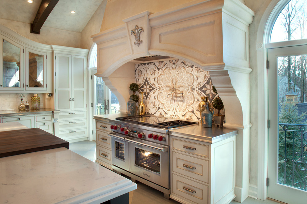 Inspiration for a large transitional eat-in kitchen in Other with an undermount sink, beaded inset cabinets, beige cabinets, white splashback, marble splashback, limestone floors, multiple islands, beige floor and grey benchtop.