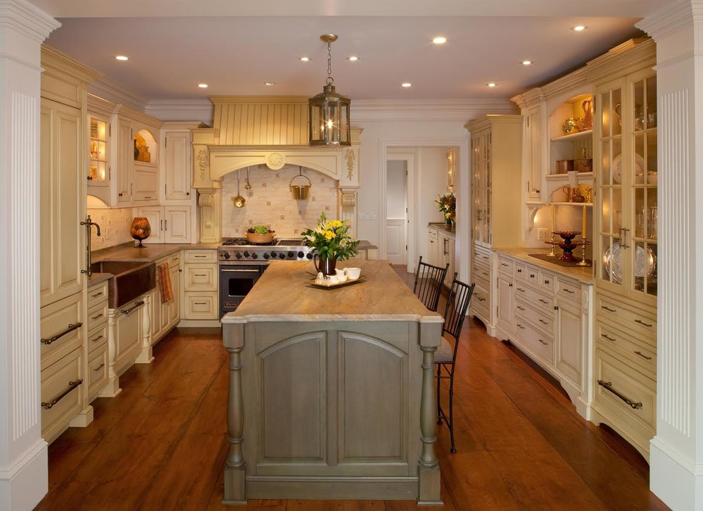 Inspiration for a mid-sized traditional l-shaped separate kitchen in DC Metro with a farmhouse sink, raised-panel cabinets, beige cabinets, granite benchtops, beige splashback, porcelain splashback, stainless steel appliances, dark hardwood floors, multiple islands and beige floor.
